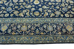Corner detail of 2000s Kashan rug showing border pattern and Wool pile