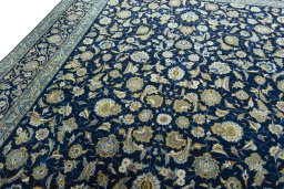 Backside of handmade 2000s Kashan rug showing knot structure and weave density