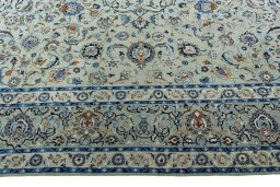 Corner detail of 2000s Kashan rug showing border pattern and Wool pile