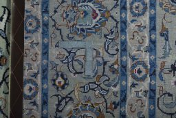 Backside of handmade 2000s Kashan rug showing knot structure and weave density