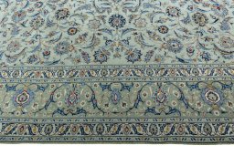 Corner detail of 2000s Kashan rug showing border pattern and Wool pile