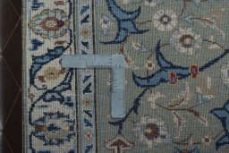 Backside of handmade 2000s Kashan rug showing knot structure and weave density