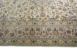 Corner detail of 2000s Kashan rug showing border pattern and Wool pile