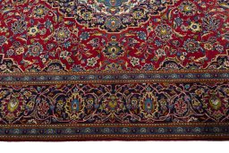 Corner detail of 2000s Kashan rug showing border pattern and Wool pile