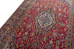 Backside of handmade 2000s Kashan rug showing knot structure and weave density