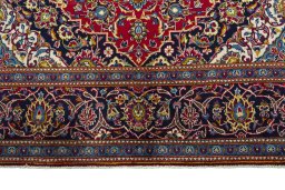Full view of 2000s Kashan rug from Iran / Persia, 302 × 196 cm in Red tones