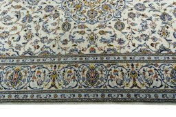Corner detail of New Kashan rug showing border pattern and Wool pile