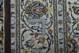 Backside of handmade New Kashan rug showing knot structure and weave density