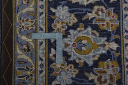 Backside of handmade 2000s Kashan rug showing knot structure and weave density