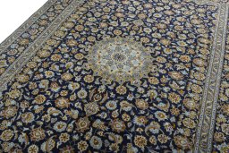 Backside of handmade 2000s Kashan rug showing knot structure and weave density