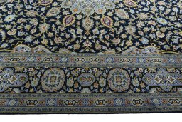 Corner detail of 2000s Kashan rug showing border pattern and Wool pile