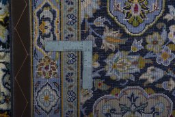 Backside of handmade 2000s Kashan rug showing knot structure and weave density