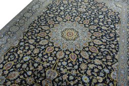 Backside of handmade 2000s Kashan rug showing knot structure and weave density