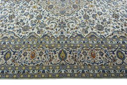 Corner detail of 2000s Kashan rug showing border pattern and Wool pile