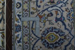 Backside of handmade 2000s Kashan rug showing knot structure and weave density