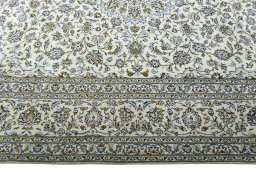 Corner detail of 2000s Kashan rug showing border pattern and Wool pile
