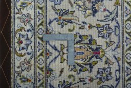 Backside of handmade 2000s Kashan rug showing knot structure and weave density