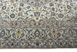 Corner detail of 2000s Kashan rug showing border pattern and Wool pile
