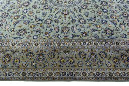 Corner detail of 2000s Kashan rug showing border pattern and Wool pile