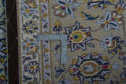 Backside of handmade 2000s Kashan rug showing knot structure and weave density
