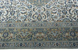 Corner detail of 2000s Kashan rug showing border pattern and Wool pile
