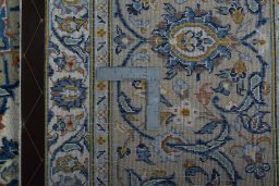 Backside of handmade 2000s Kashan rug showing knot structure and weave density