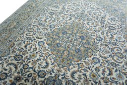 Backside of handmade 2000s Kashan rug showing knot structure and weave density