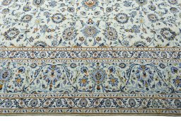 Corner detail of 2000s Kashan rug showing border pattern and Wool pile