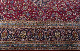 Corner detail of 2000s Kashan rug showing border pattern and Wool pile