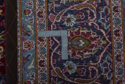 Backside of handmade 2000s Kashan rug showing knot structure and weave density