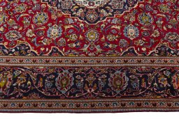 Corner detail of 2000s Kashan rug showing border pattern and Wool pile