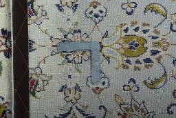 Backside of handmade 2000s Kashan rug showing knot structure and weave density