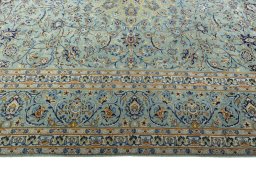 Corner detail of 2000s Kashan rug showing border pattern and Wool pile
