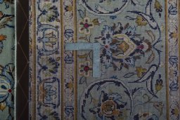 Backside of handmade 2000s Kashan rug showing knot structure and weave density