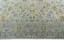 Corner detail of 2000s Kashan rug showing border pattern and Wool pile