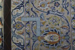 Backside of handmade 2000s Kashan rug showing knot structure and weave density
