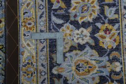 Backside of handmade 2000s Kashan rug showing knot structure and weave density