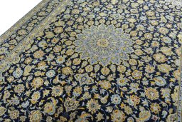 Backside of handmade 2000s Kashan rug showing knot structure and weave density