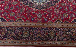 Corner detail of 2000s Kashan rug showing border pattern and Wool pile
