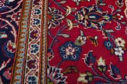 Backside of handmade 2000s Kashan rug showing knot structure and weave density