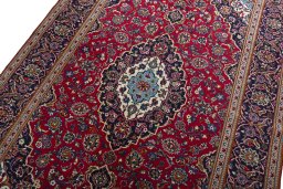 Backside of handmade 2000s Kashan rug showing knot structure and weave density
