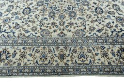 Corner detail of 2000s Kashan rug showing border pattern and Wool pile