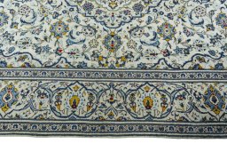 Corner detail of 2000s Kashan rug showing border pattern and Wool pile