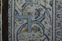 Backside of handmade 2000s Kashan rug showing knot structure and weave density