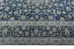 Corner detail of 2000s Kashan rug showing border pattern and Wool pile