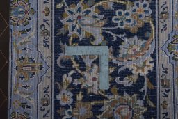 Backside of handmade 2000s Kashan rug showing knot structure and weave density