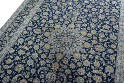 Backside of handmade 2000s Kashan rug showing knot structure and weave density