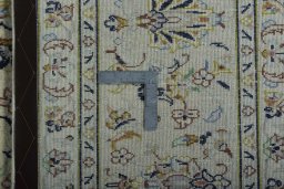 Backside of handmade New Kashan rug showing knot structure and weave density
