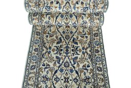 Corner detail of 2000s Kashan rug showing border pattern and Wool pile