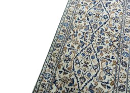 Backside of handmade 2000s Kashan rug showing knot structure and weave density